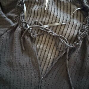 Free people black blouse with tie front and beautiful details.